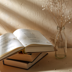 A pile of books on a surface with sticks in a vase, illustrating that you don't have to struggle forever with the symptoms of PTSD. Exposure Therapy Designs can help.