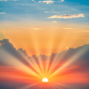 Sun setting in the horizon with beams shooting out into the sky illustrating that Exposure Therapy Designs can help you break free from PTSD and OCD.